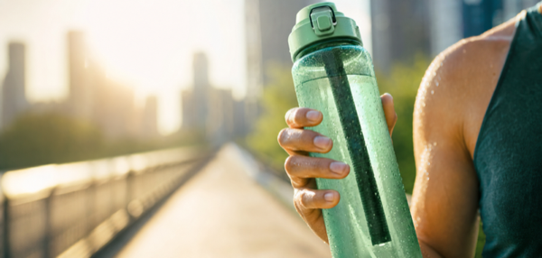 Green activated charcoal bottle on a studio set